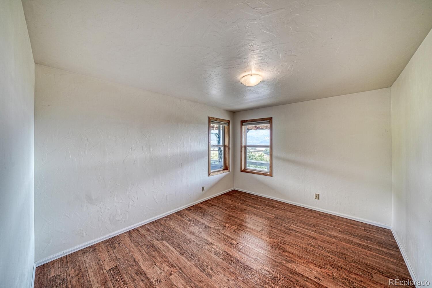 236 Boreen Way Howard, CO 81233 - Photo 19 of 30 wooden floor in an empty room with a window