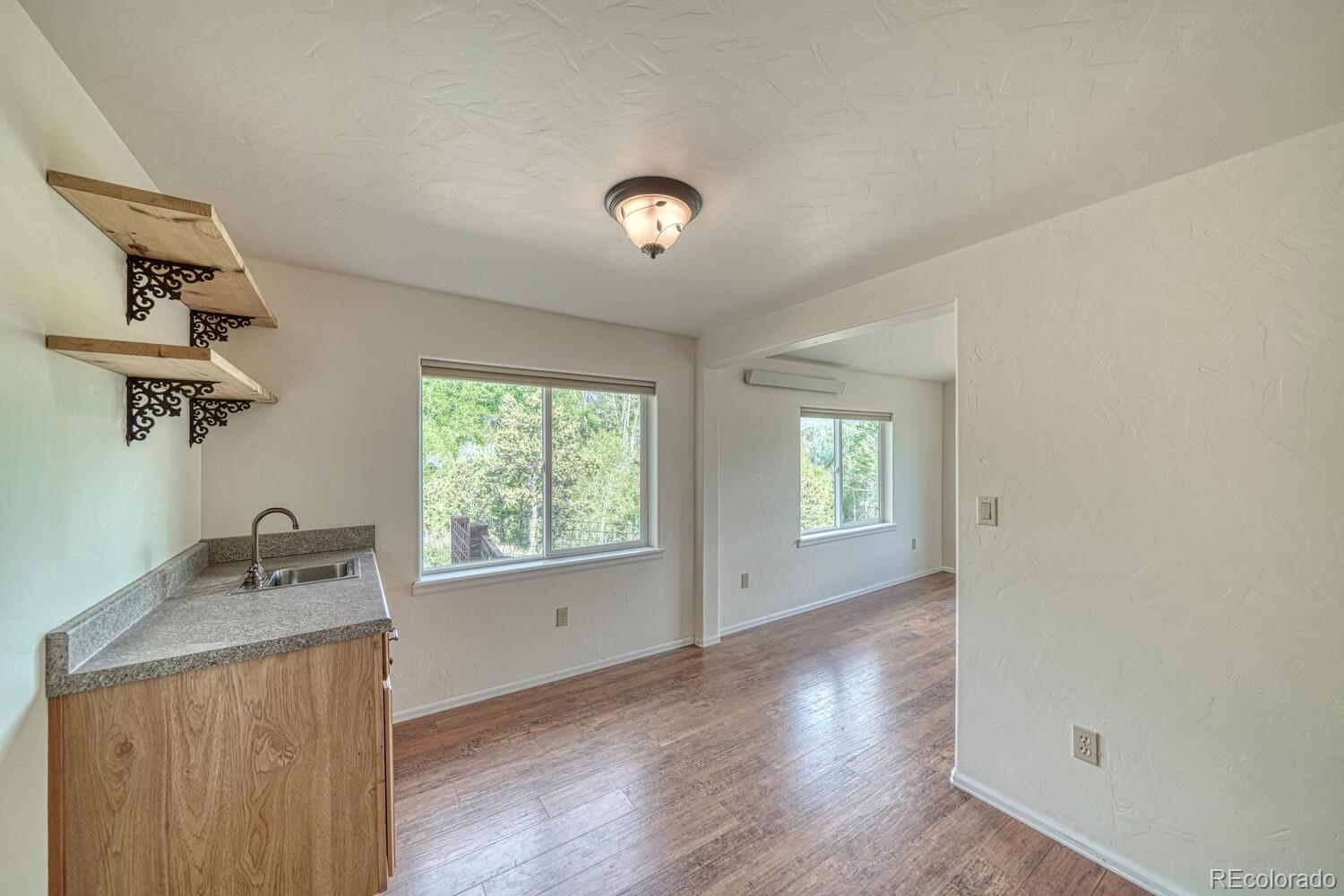 236 Boreen Way Howard, CO 81233 - Photo 21 of 30 a view of an empty room with a window and wooden floor