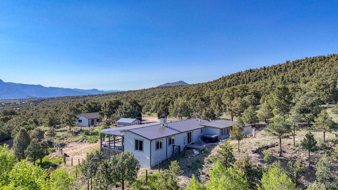 236 Boreen Way Howard, CO 81233 - Photo 5 of 30 a view of a big house with a mountain in the background