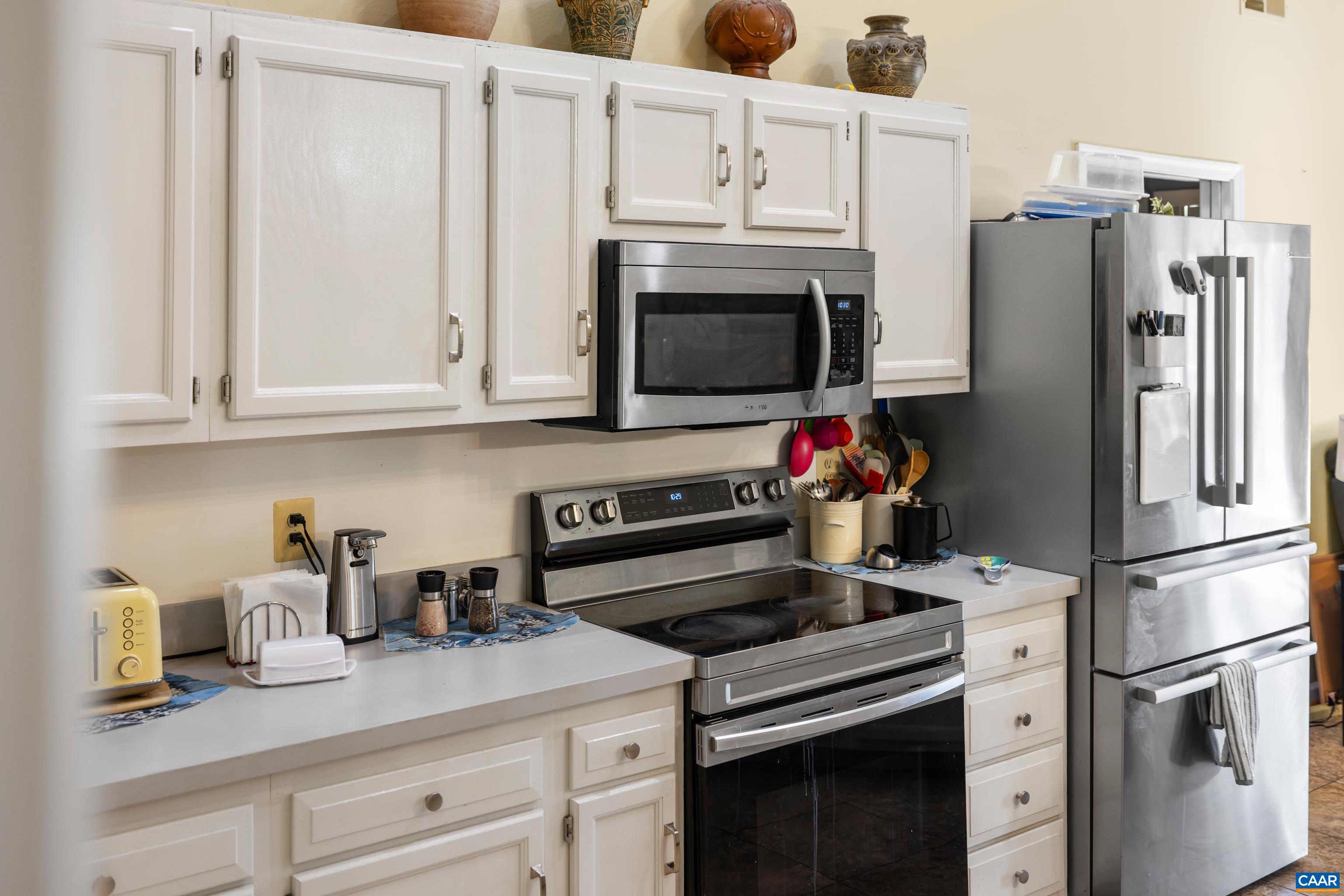 465 Hidden Ridge Road Charlottesville, VA 22902 - Photo 14 of 63 a kitchen with granite countertop white cabinets stainless steel appliances and wooden cabinets