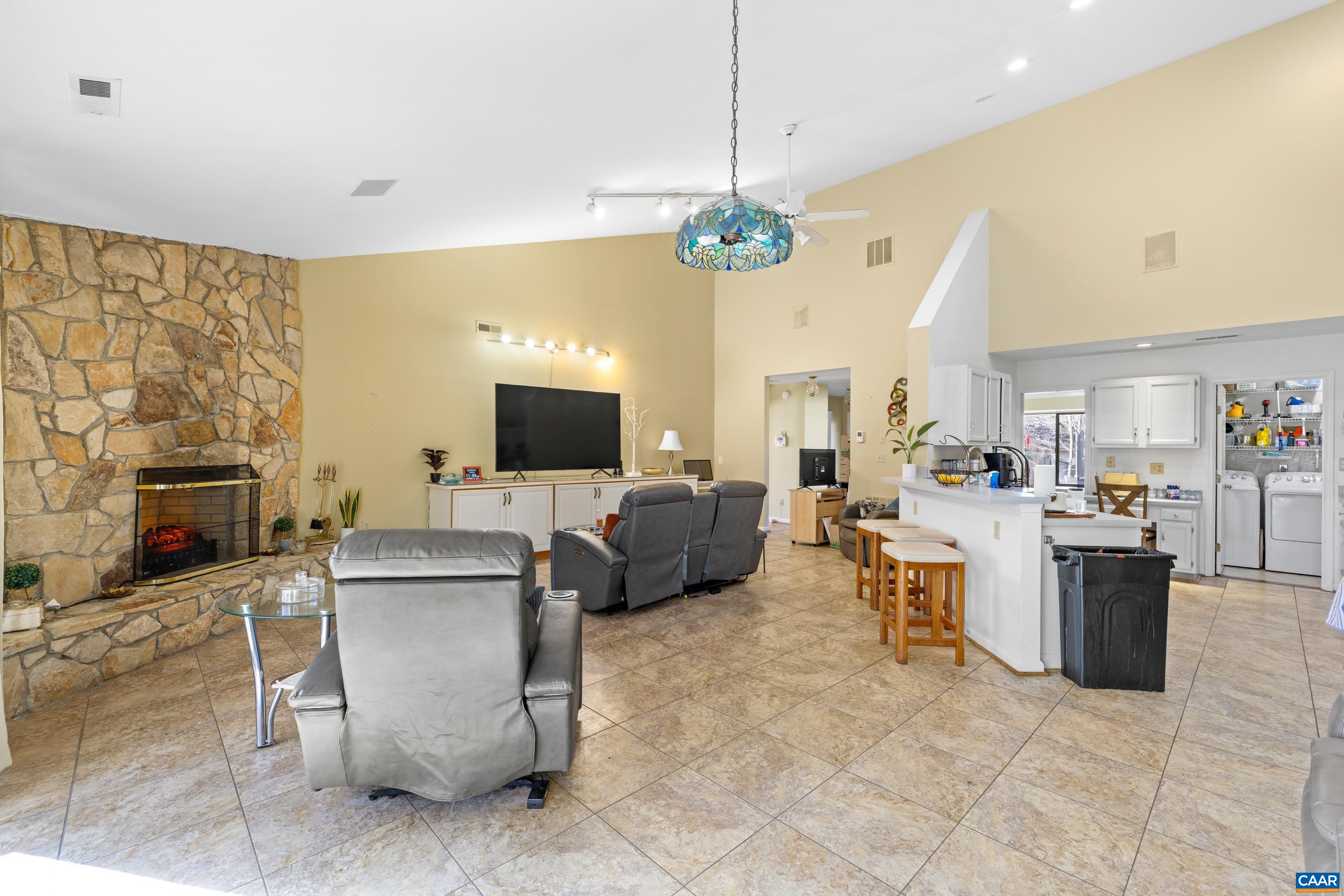465 Hidden Ridge Road Charlottesville, VA 22902 - Photo 19 of 63 a living room with furniture a fireplace and a flat screen tv