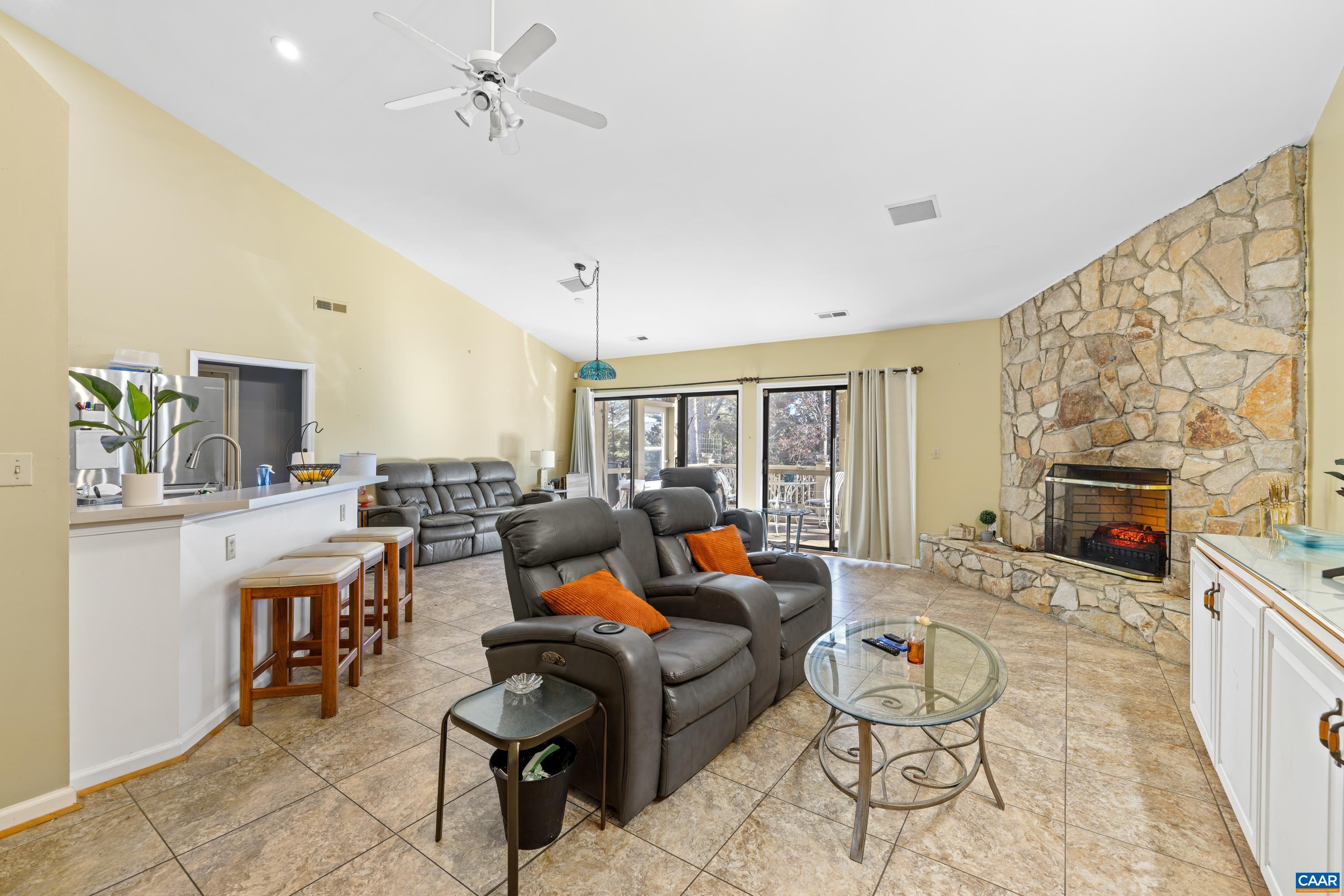 465 Hidden Ridge Road Charlottesville, VA 22902 - Photo 24 of 63 a living room with fireplace furniture and a flat screen tv