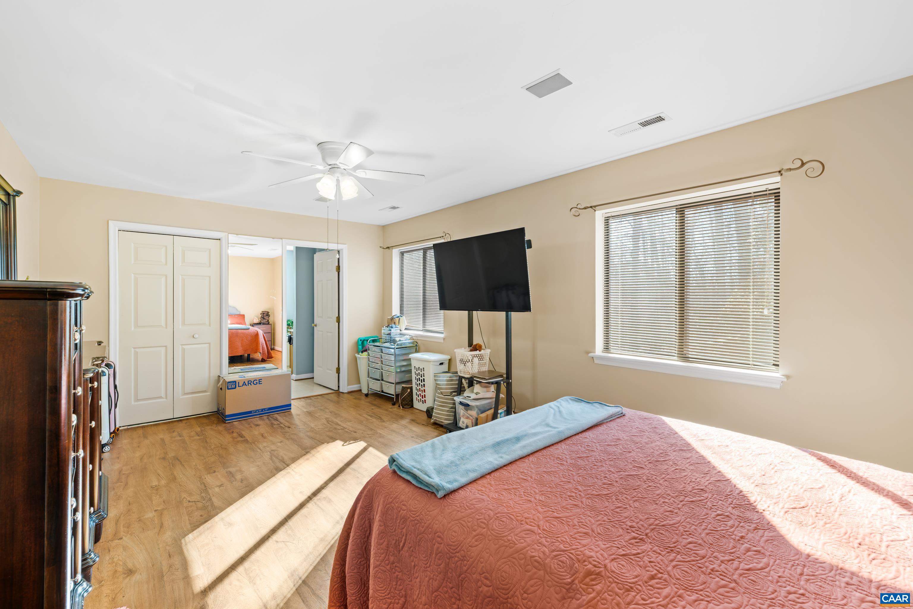465 Hidden Ridge Road Charlottesville, VA 22902 - Photo 26 of 63 a bedroom with a bed flat screen tv and a window