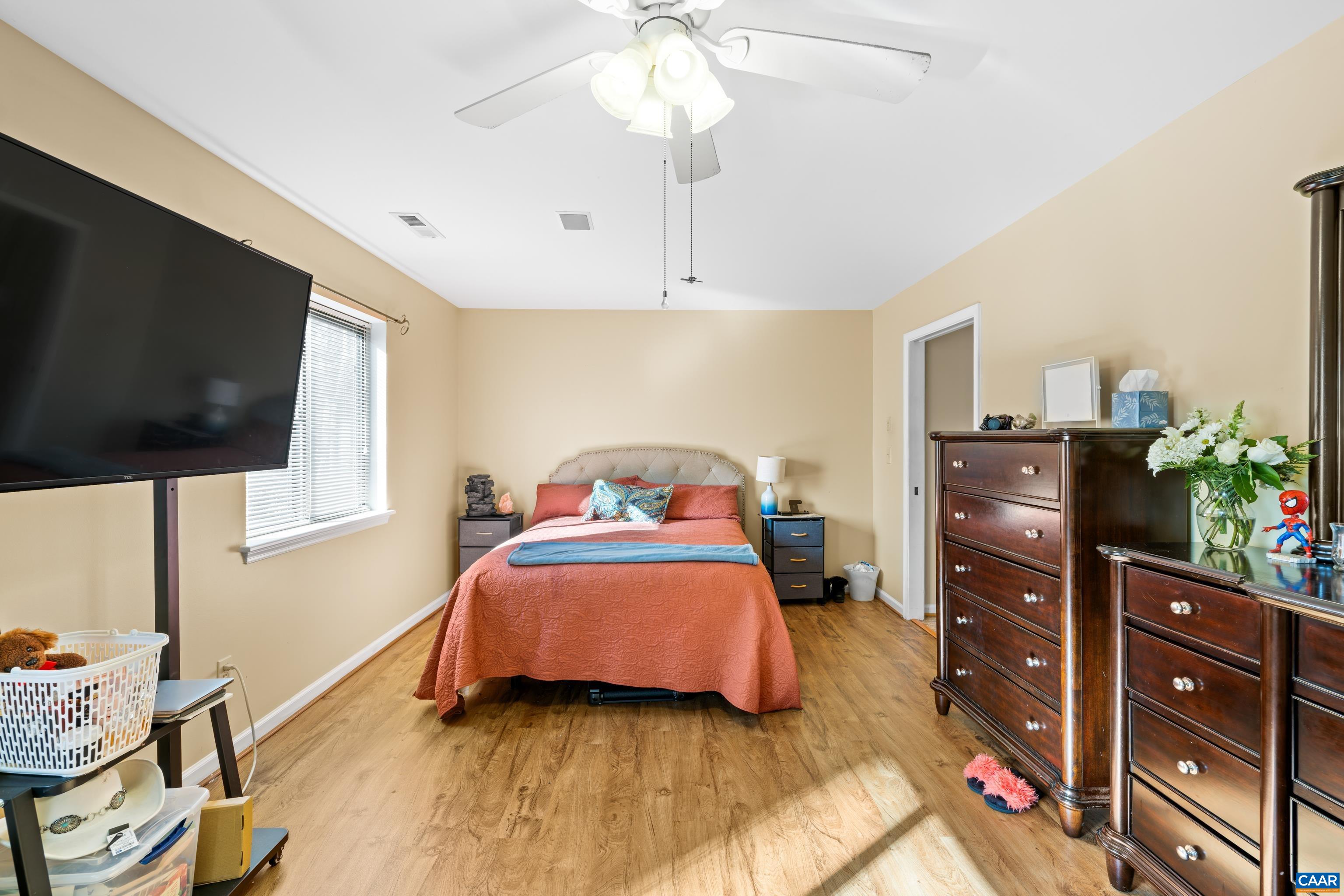 465 Hidden Ridge Road Charlottesville, VA 22902 - Photo 27 of 63 a bedroom with a bed and flat tv screen on dresser