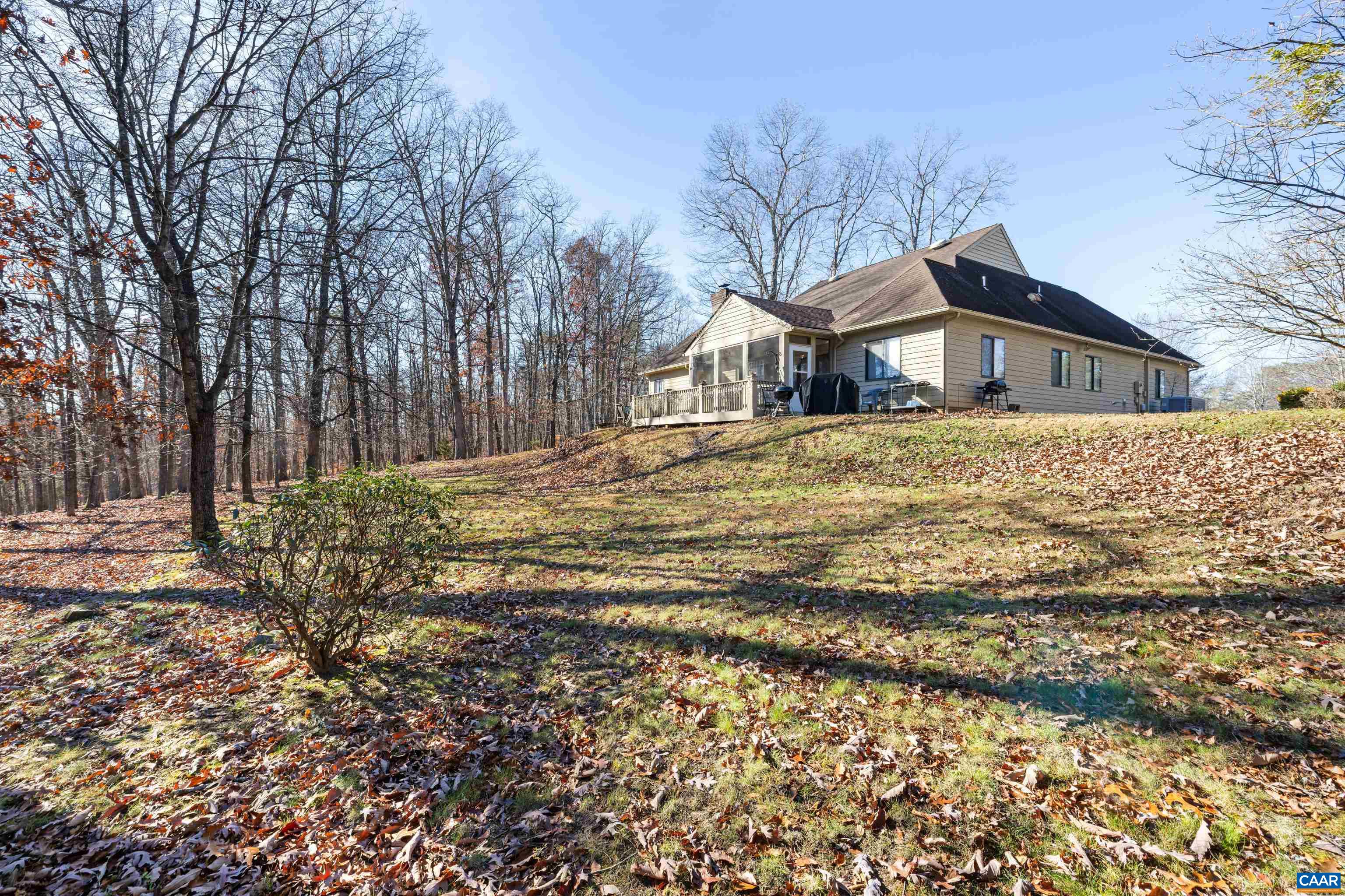 465 Hidden Ridge Road Charlottesville, VA 22902 - Photo 50 of 63 a front view of a house with a yard covered with snow and trees