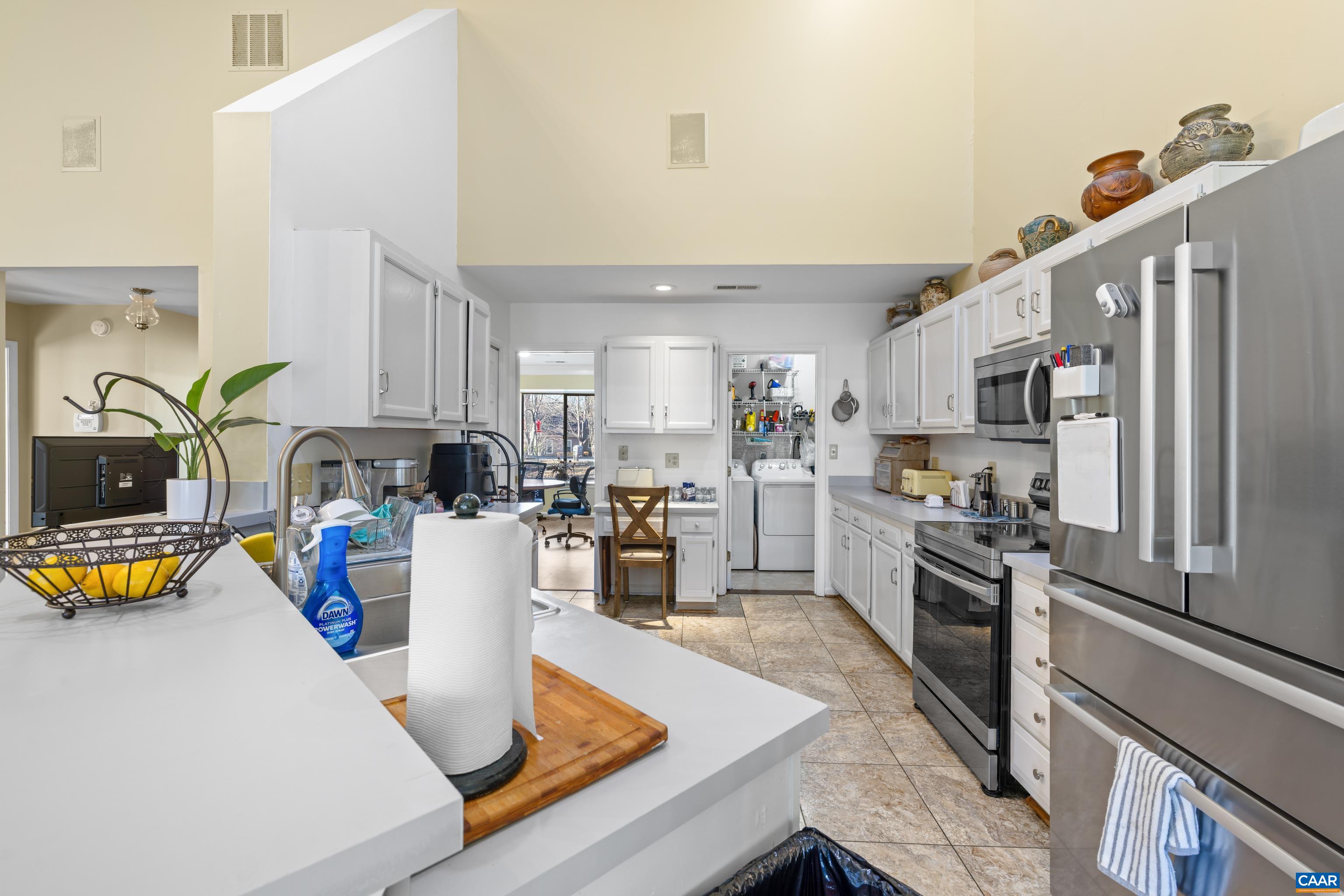 465 Hidden Ridge Road Charlottesville, VA 22902 - Photo 9 of 63 a kitchen with a refrigerator a stove and a sink with wooden floor