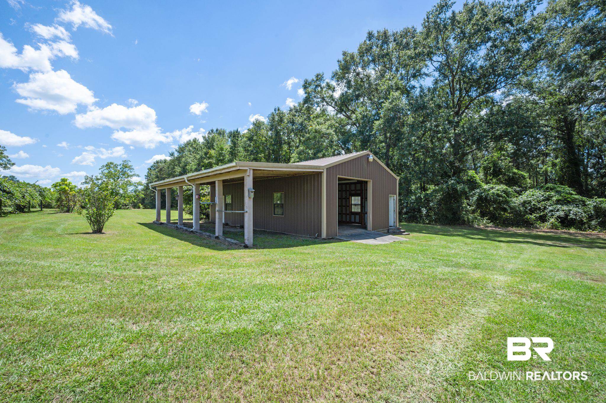 15880 Pine Grove Rd Extension West Bay Minette, AL 36507 - Photo 8 of 44 View of yard with a garage and an outbuilding