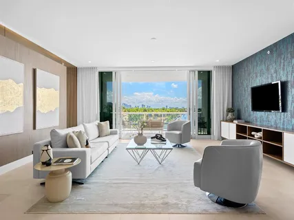 a large kitchen with lots of counter top and a view of living room
