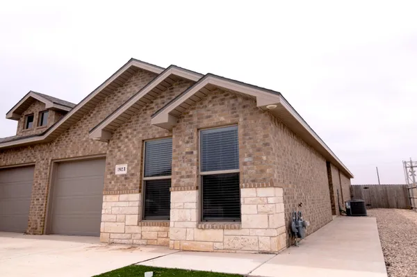 a front view of a house with white walls