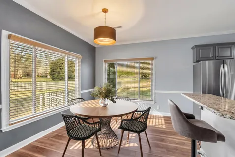a dining room with furniture and window