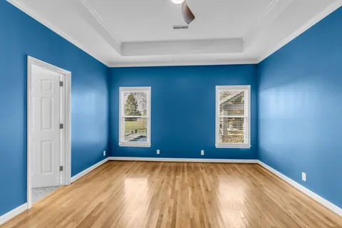 an empty room with windows and closet