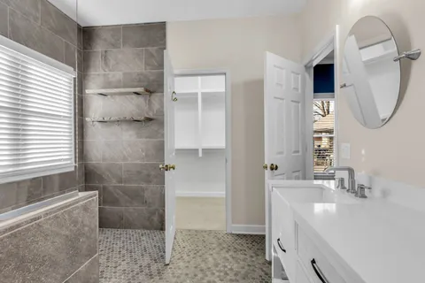 a bathroom with a sink a toilet and a mirror