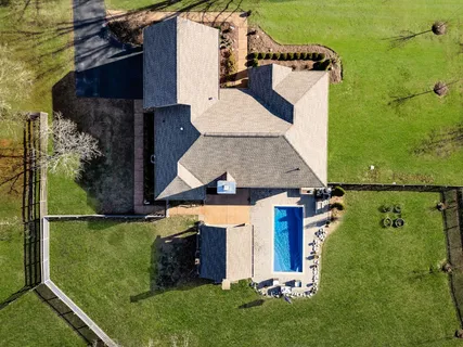 an aerial view of a house with a yard