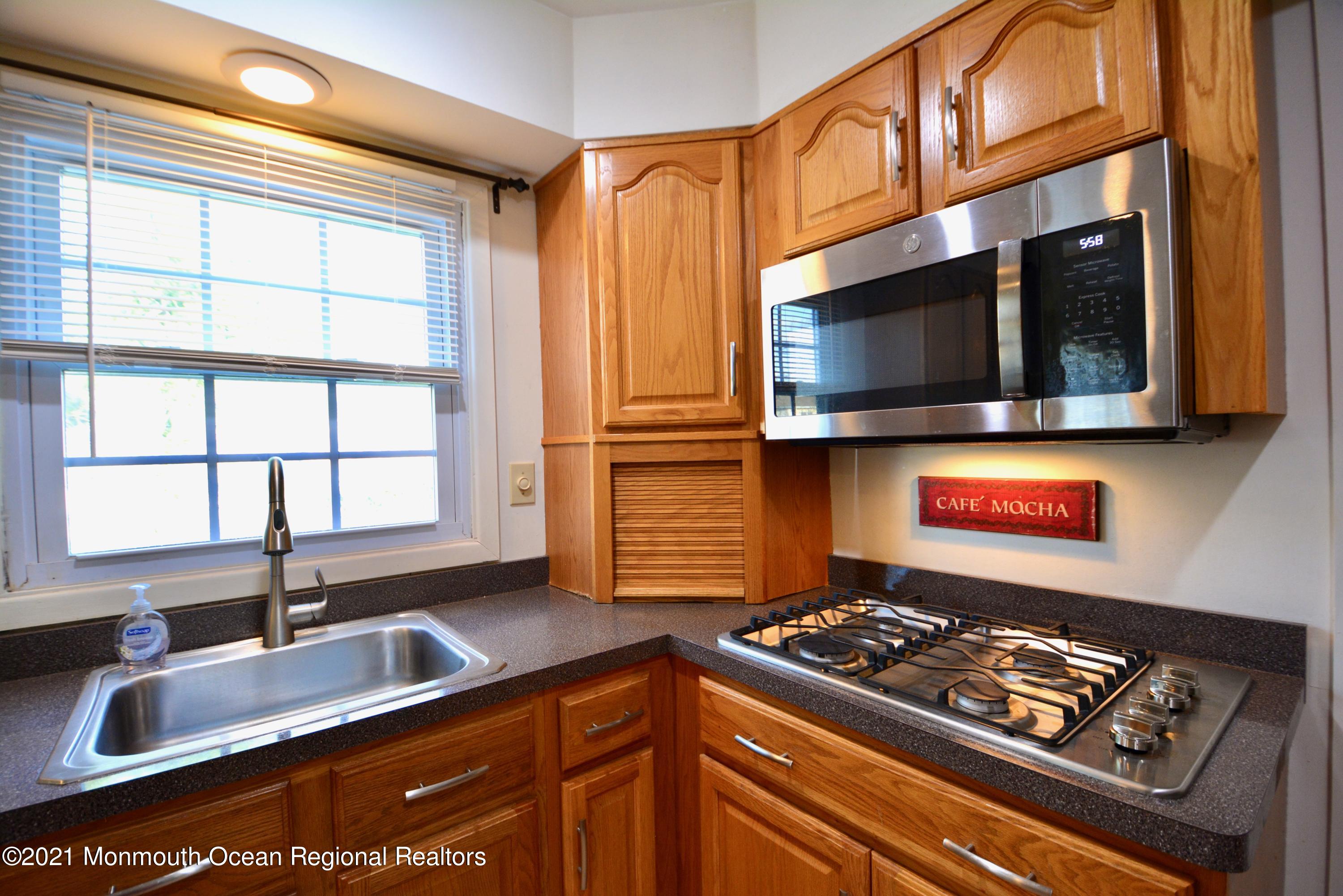 584 Lloyd Road Aberdeen, NJ 07747 - Photo 5 of 5 a kitchen with stainless steel appliances granite countertop a stove and a sink