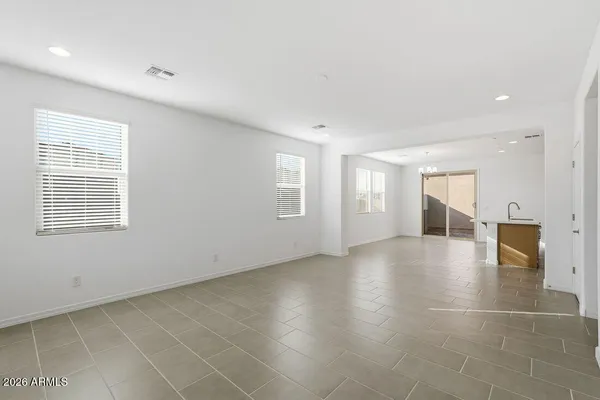 a view of an empty room with a window and fireplace