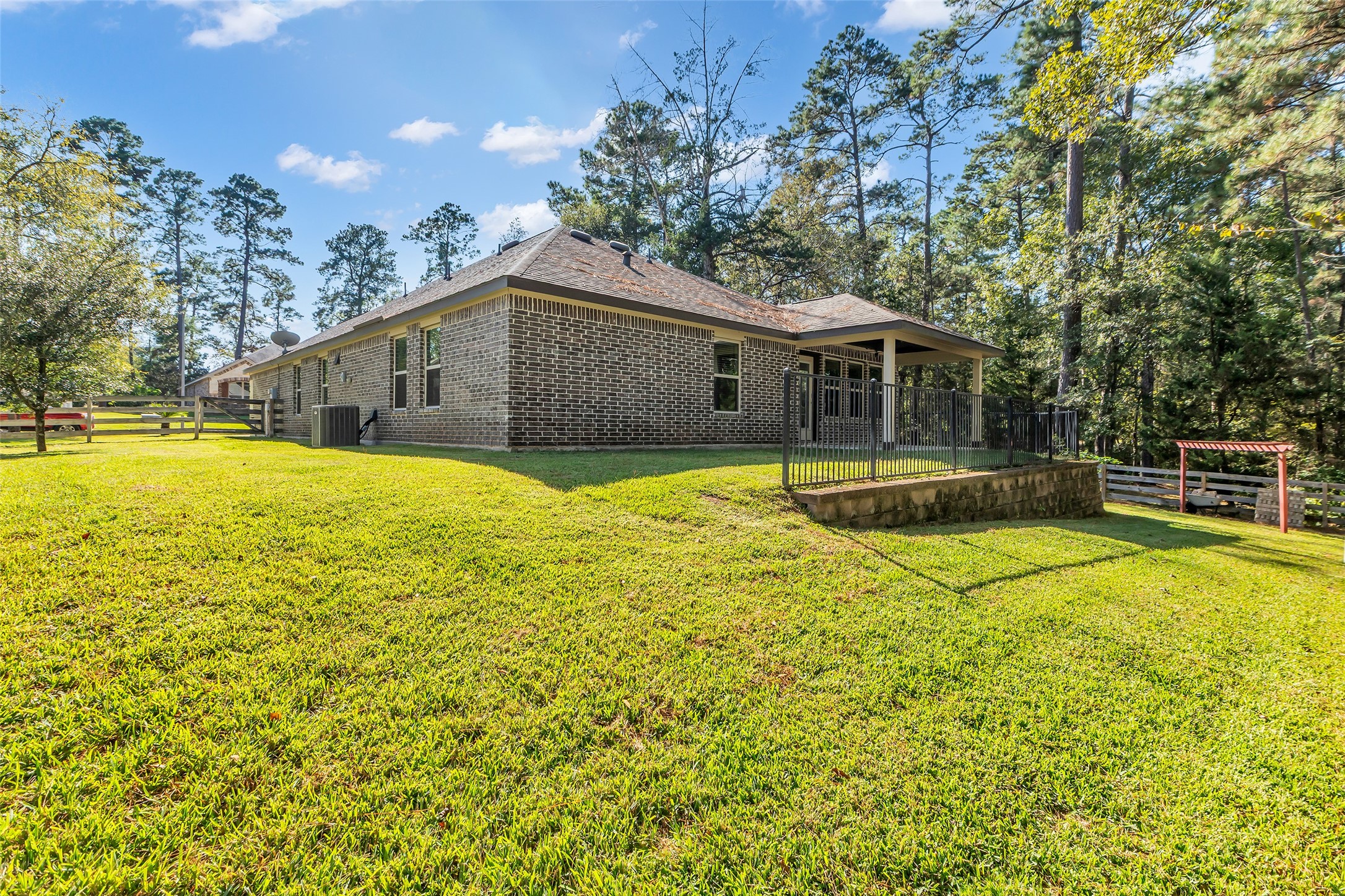 9023 South Comanche Circle Willis, TX 77378 - Photo 22 of 28 a view of a house with swimming pool and a yard