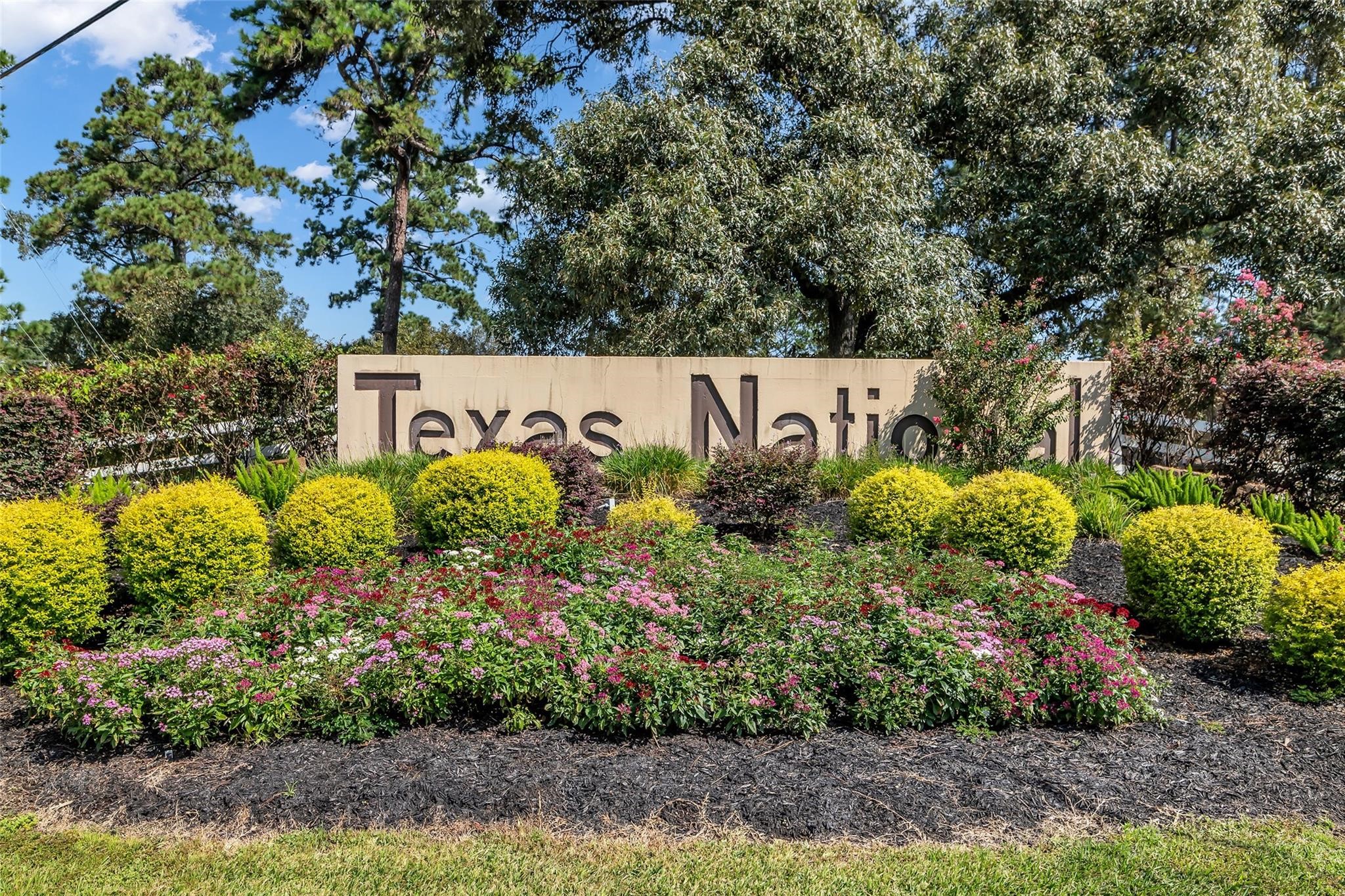 9023 South Comanche Circle Willis, TX 77378 - Photo 27 of 28 a sign that is sitting in front of flowers