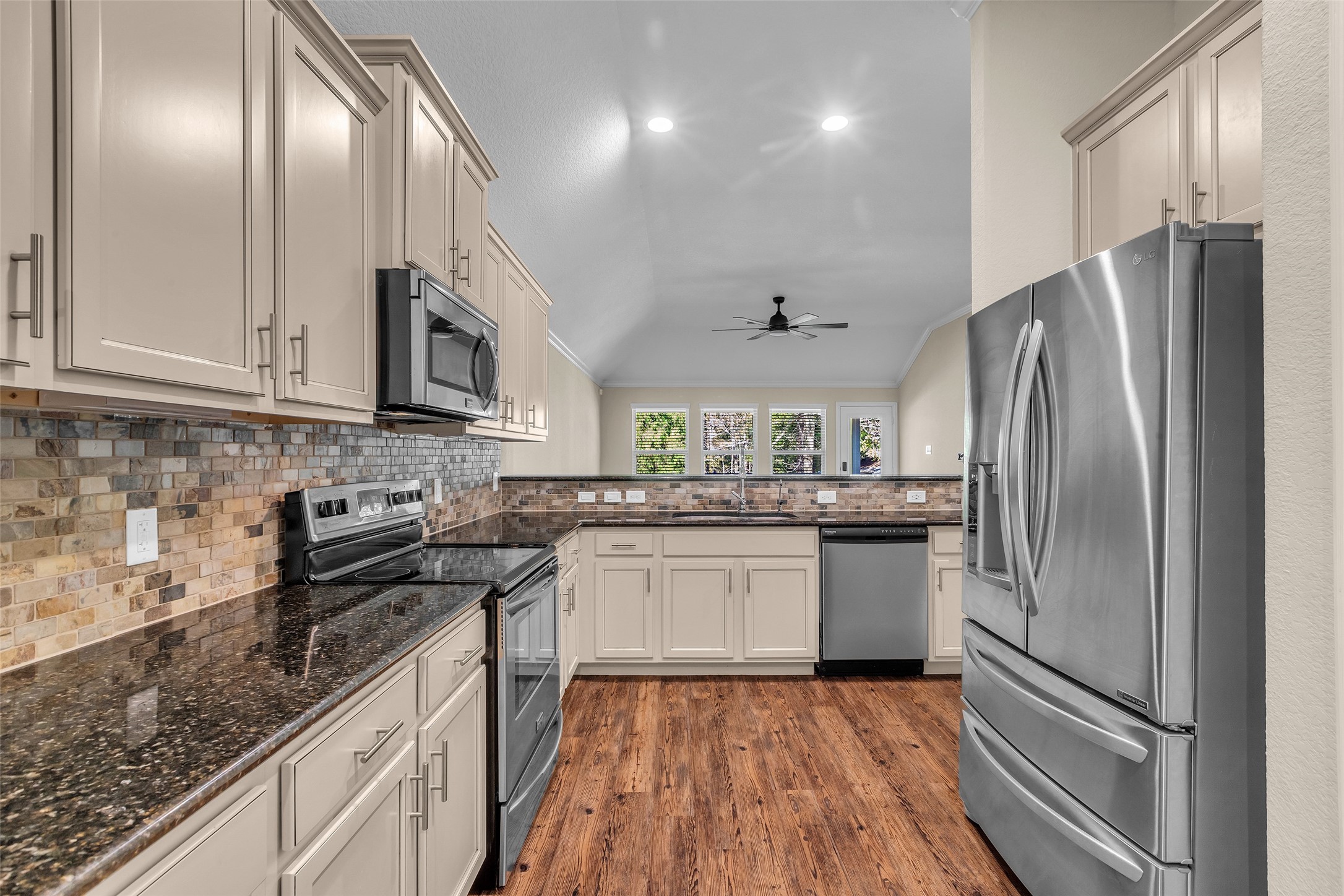 9023 South Comanche Circle Willis, TX 77378 - Photo 6 of 28 a kitchen with a sink stainless steel appliances and cabinets
