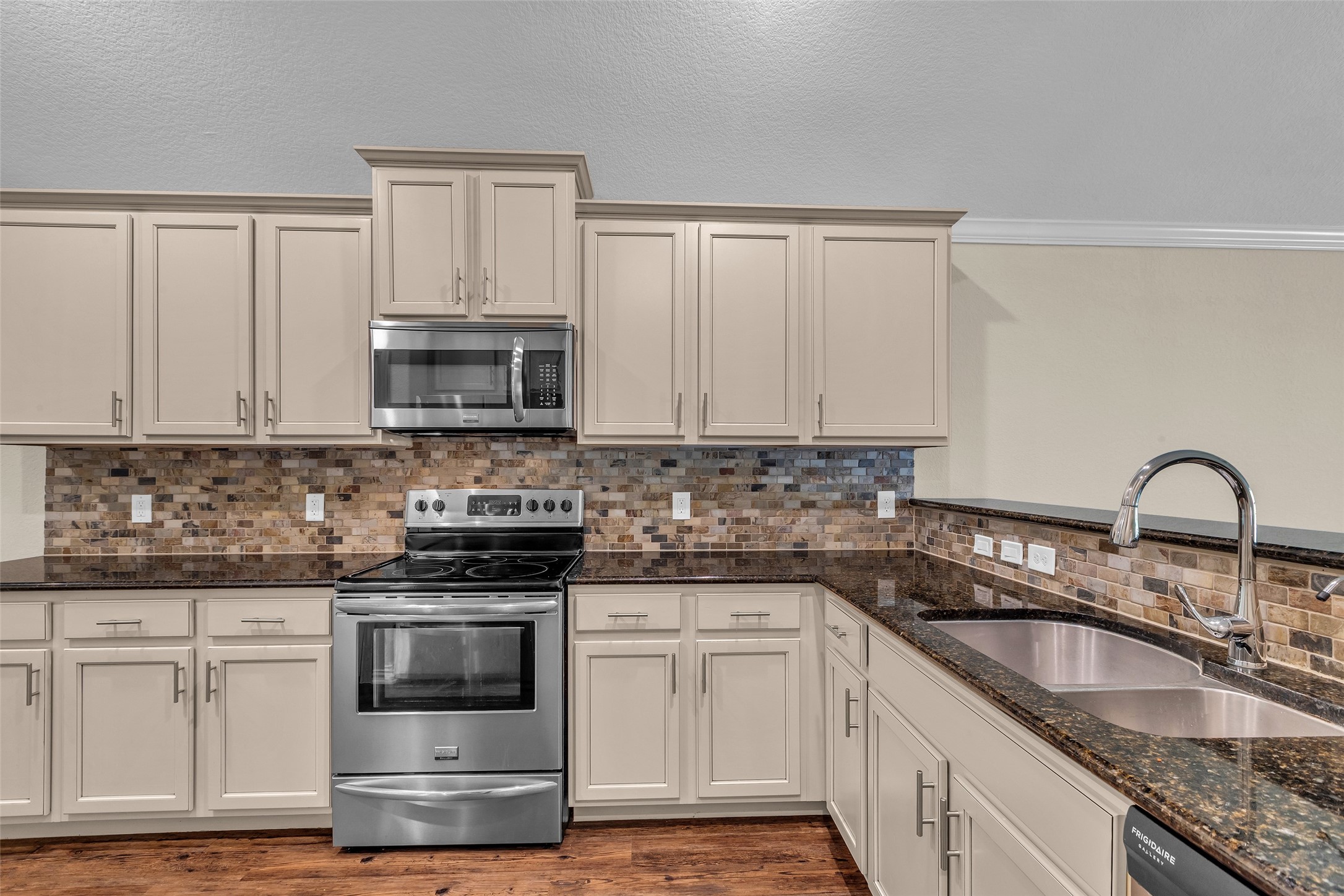 9023 South Comanche Circle Willis, TX 77378 - Photo 7 of 28 a kitchen with granite countertop white cabinets and stainless steel appliances