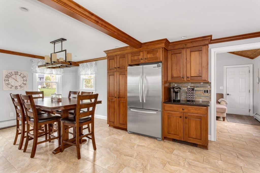 19 Colt Road Franklin, MA 02038 - Photo 11 of 36 a kitchen with stainless steel appliances kitchen island granite countertop a table and chairs
