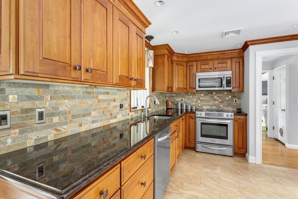 19 Colt Road Franklin, MA 02038 - Photo 12 of 36 a kitchen with stainless steel appliances granite countertop a sink a stove and cabinets