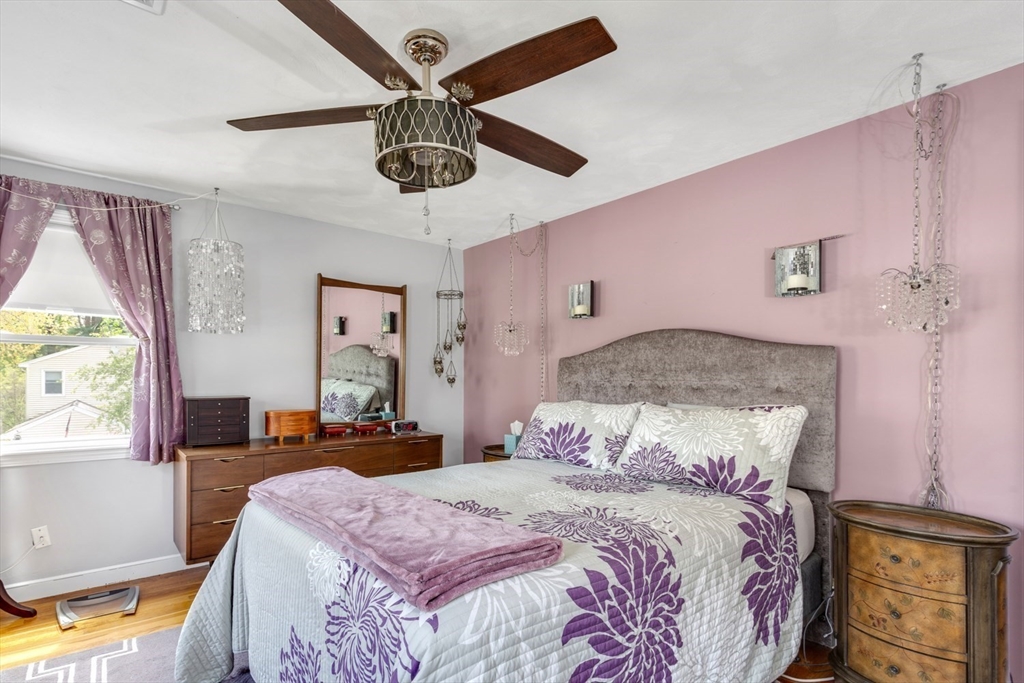 19 Colt Road Franklin, MA 02038 - Photo 21 of 36 a bedroom with a bed chandelier and a window