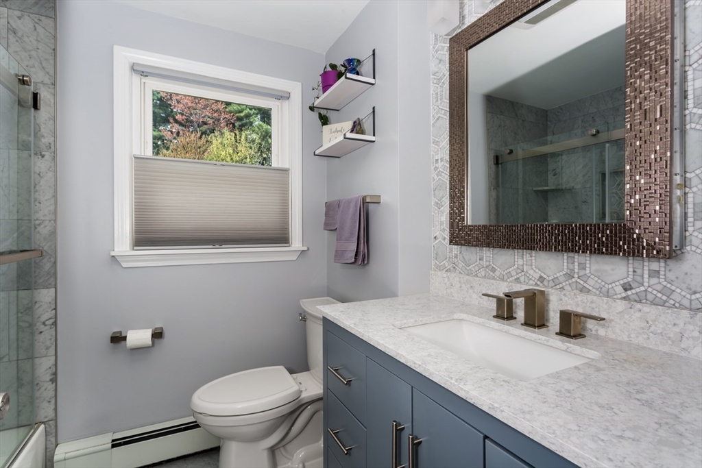 19 Colt Road Franklin, MA 02038 - Photo 28 of 36 a bathroom with a granite countertop toilet sink and mirror