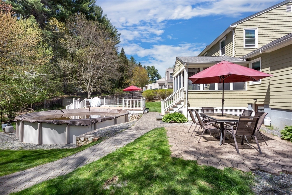 19 Colt Road Franklin, MA 02038 - Photo 32 of 36 a view of a patio with table and chairs under an umbrella