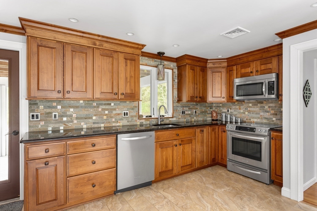 19 Colt Road Franklin, MA 02038 - Photo 10 of 36 a kitchen with stainless steel appliances granite countertop a stove and cabinets