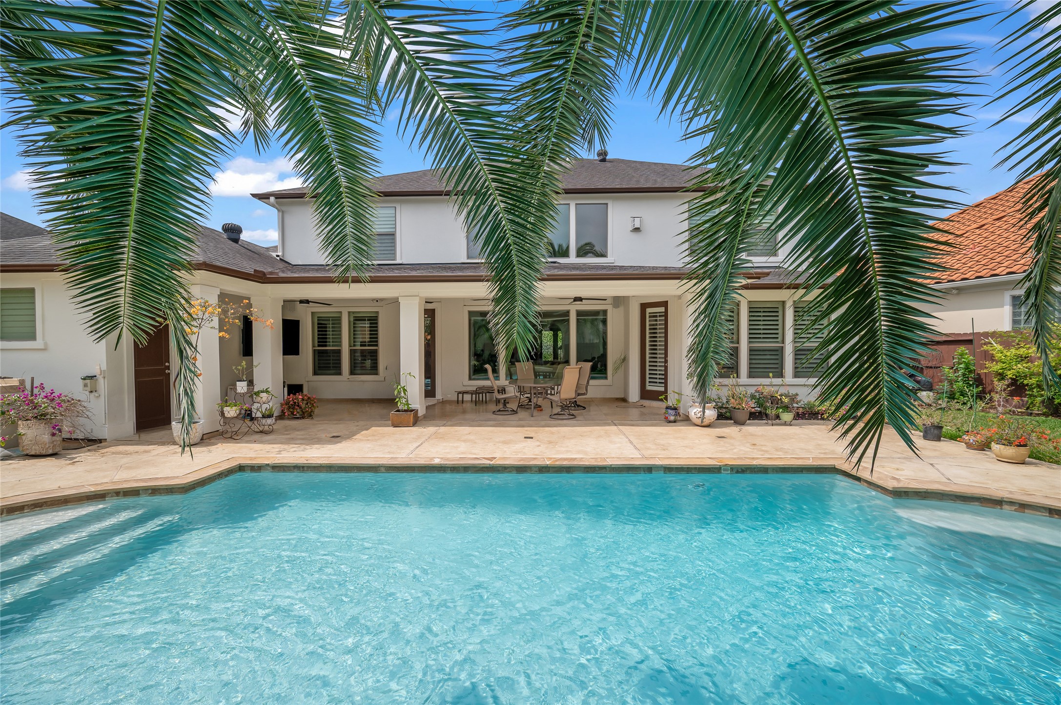 2127 Thicket Ridge Lane Houston, TX 77077 - Photo 35 of 48 The mature and stately palms help frame the view of the oversized back patio area and multiple seating areas.
