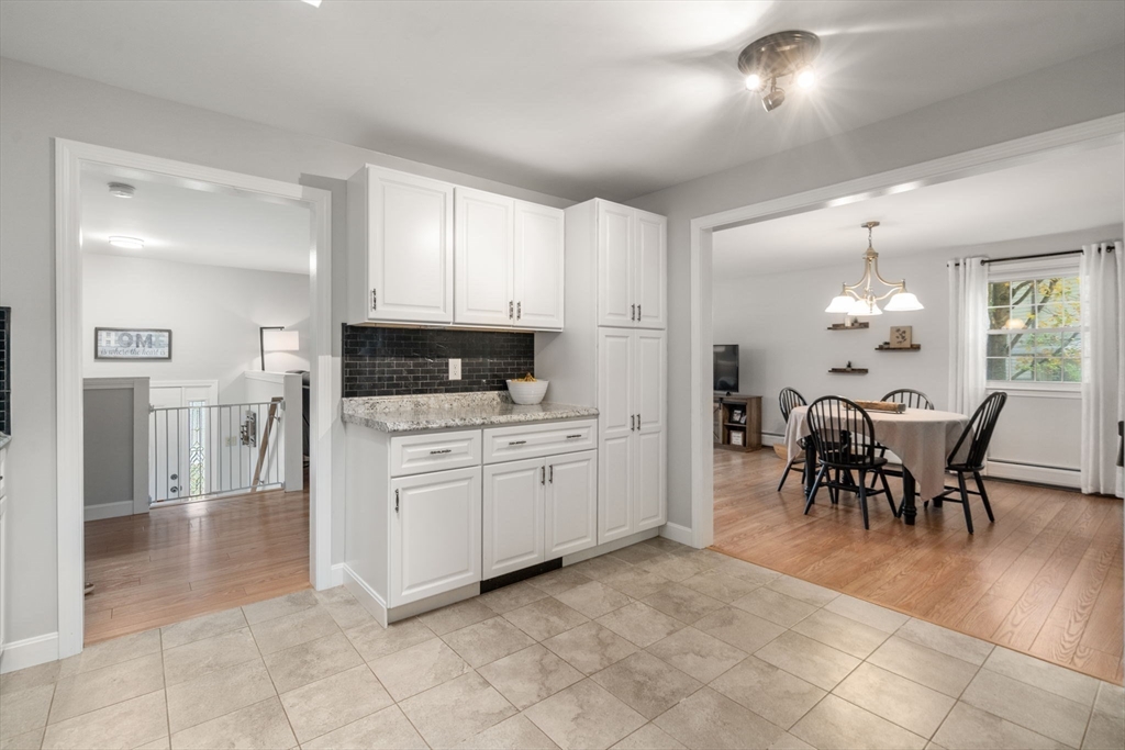 36 Depot Road Templeton, MA 01468 - Photo 11 of 38 a kitchen with granite countertop cabinets a table and chairs in it