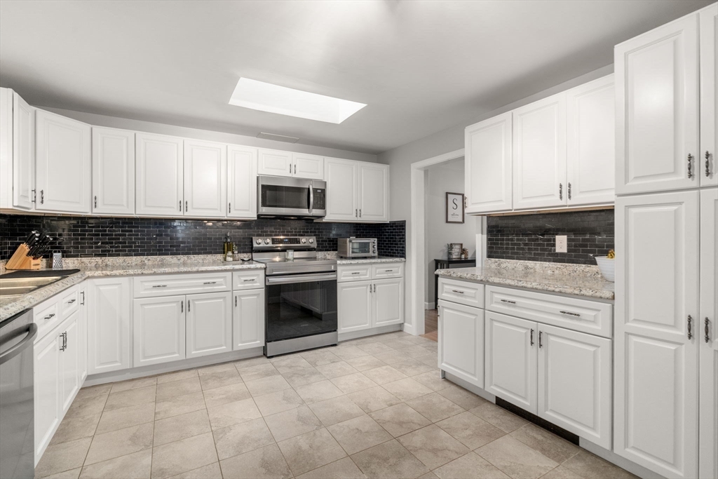 36 Depot Road Templeton, MA 01468 - Photo 10 of 38 a kitchen with granite countertop white cabinets and stainless steel appliances