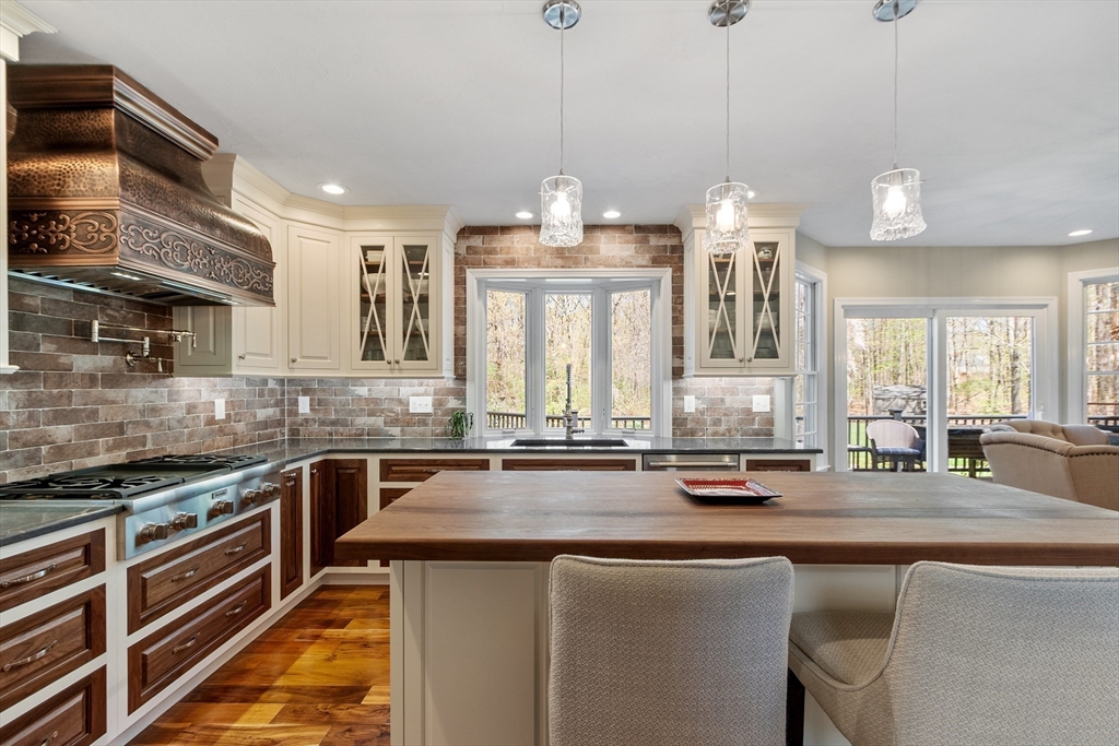 116 Coburn Road Berlin, MA 01503 - Photo 11 of 42 a kitchen with stainless steel appliances a sink stove and cabinets