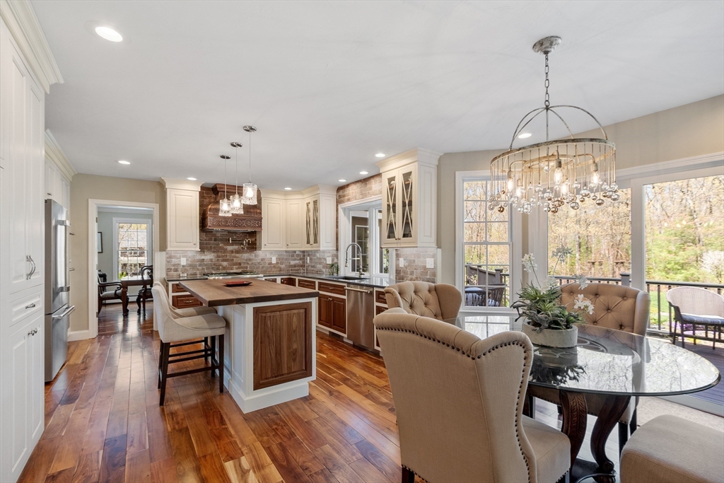 116 Coburn Road Berlin, MA 01503 - Photo 12 of 42 a view of a dining room and livingroom with furniture wooden floor a chandelier
