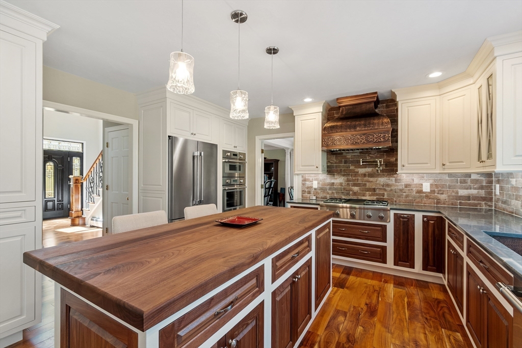 116 Coburn Road Berlin, MA 01503 - Photo 13 of 42 a kitchen with stainless steel appliances a sink stove and refrigerator