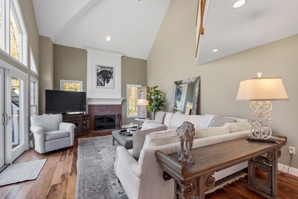 116 Coburn Road Berlin, MA 01503 - Photo 20 of 42 a living room with furniture a fireplace and a table