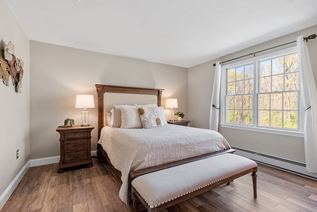 116 Coburn Road Berlin, MA 01503 - Photo 28 of 42 a bedroom with a bed and wooden floor