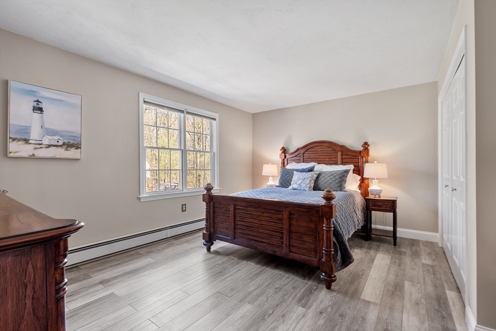 116 Coburn Road Berlin, MA 01503 - Photo 29 of 42 a bedroom with a bed and wooden floor
