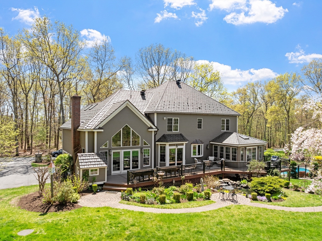 116 Coburn Road Berlin, MA 01503 - Photo 3 of 42 a front view of a house with swimming pool yard and outdoor seating