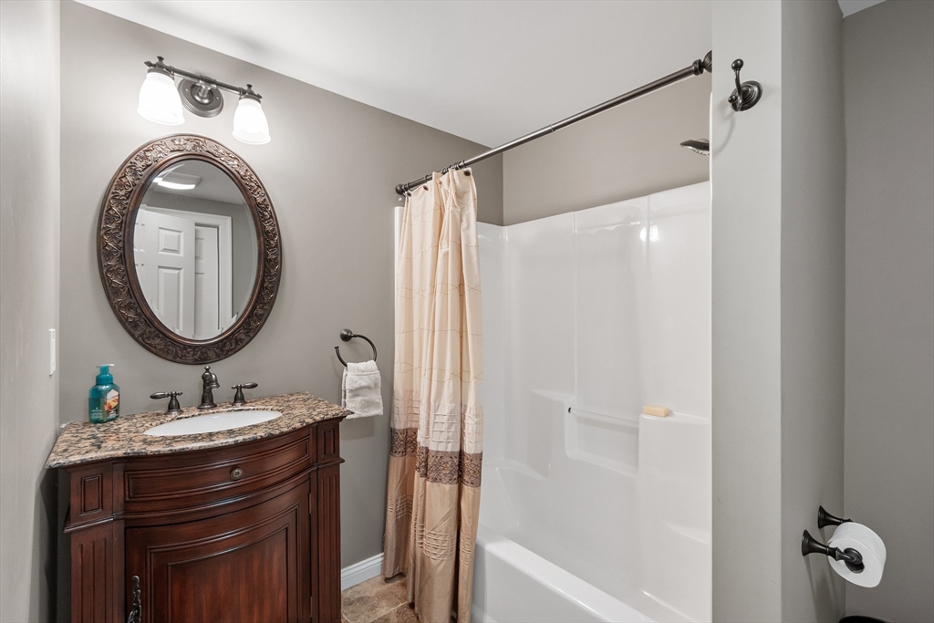 116 Coburn Road Berlin, MA 01503 - Photo 36 of 42 a bathroom with a sink vanity mirror and a bathtub