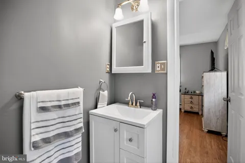 a bedroom with a large bed and a flat tv screen on dresser