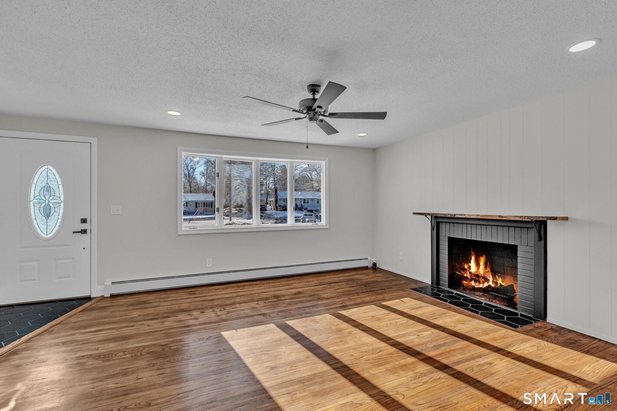 22 Mohawk Circle Newington, CT 06111 - Photo 13 of 39 a view of an empty room with wooden floor fireplace and a window