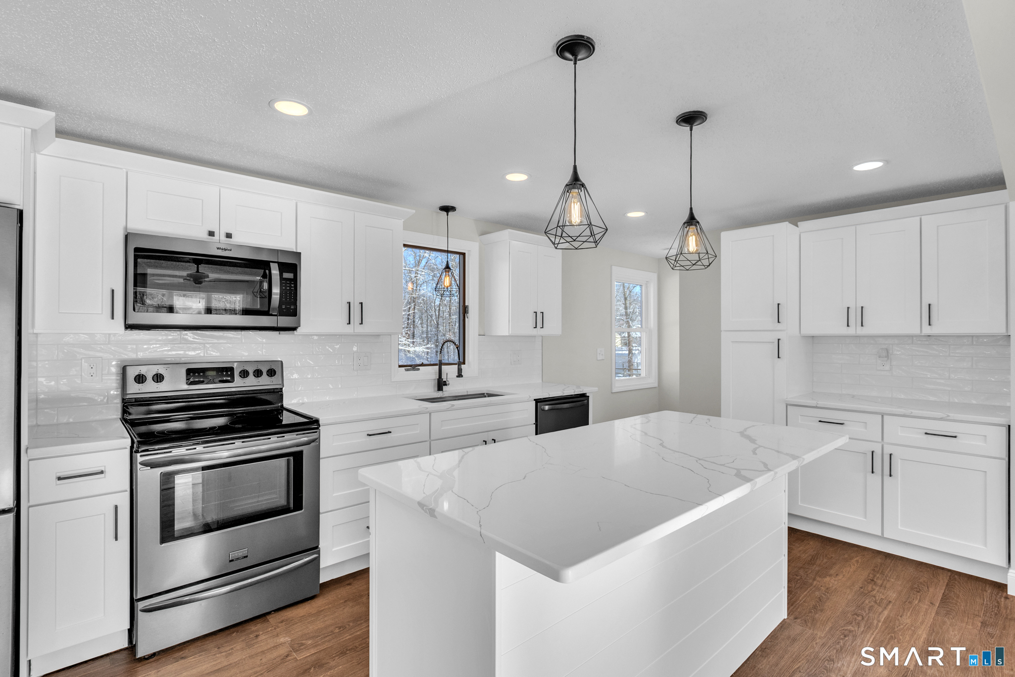 22 Mohawk Circle Newington, CT 06111 - Photo 14 of 39 a kitchen with stainless steel appliances kitchen island granite countertop a sink a stove a microwave and a refrigerator