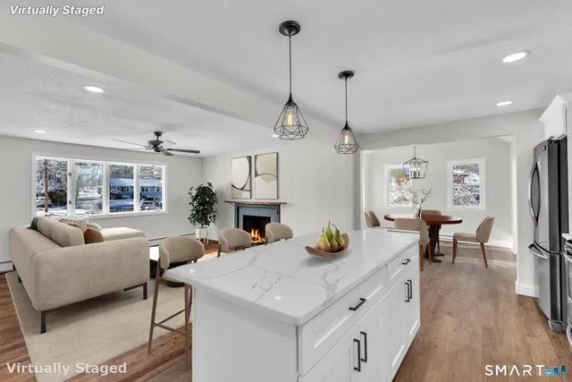 a kitchen with sink refrigerator dining table and chairs