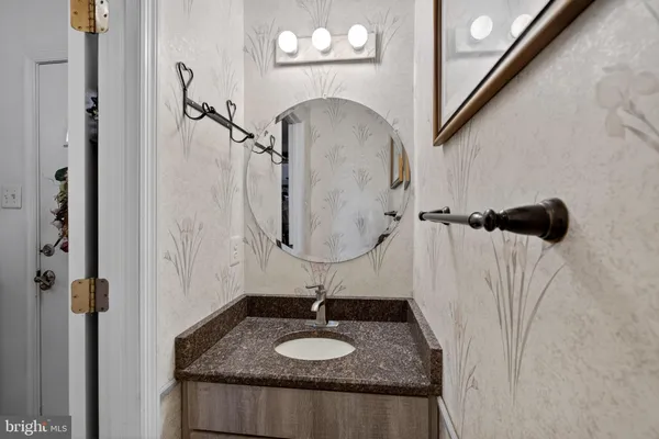 a bathroom with a sink a mirror and shower
