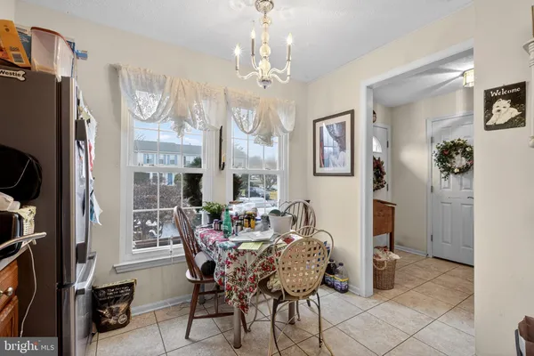 a dining room with furniture a chandelier and wooden floor