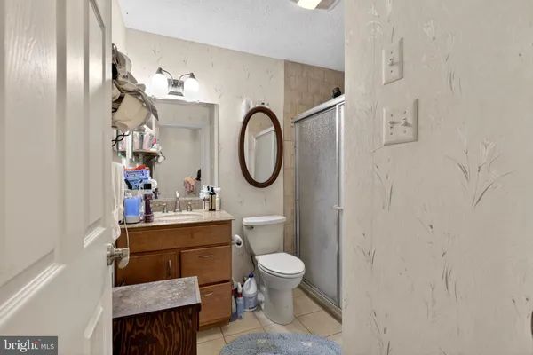 a bathroom with a toilet a sink and a mirror