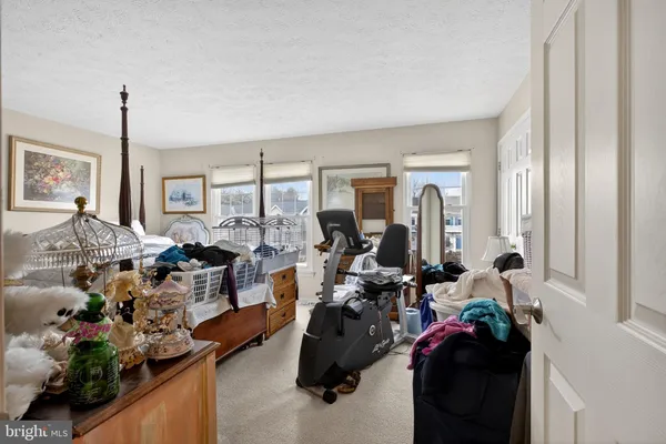 a room with gym equipment and large windows