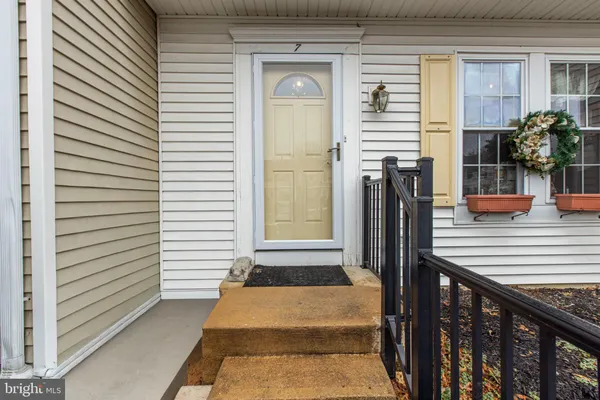 a view of a balcony with chairs and potted plants