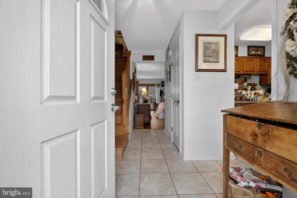 a view of a hallway with wooden cabinet and a living room
